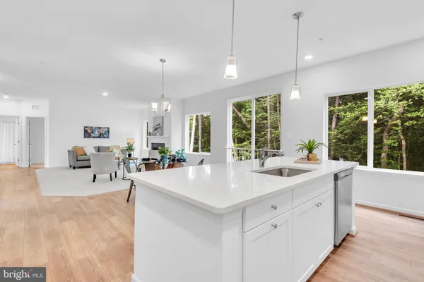 a large white kitchen with a large window