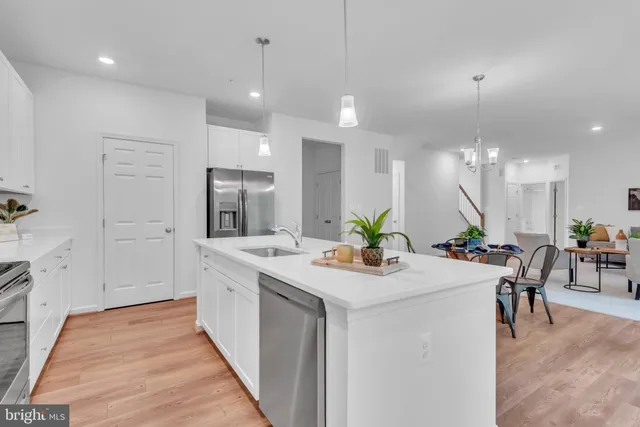 a kitchen with a sink a counter top space stainless steel appliances and cabinets