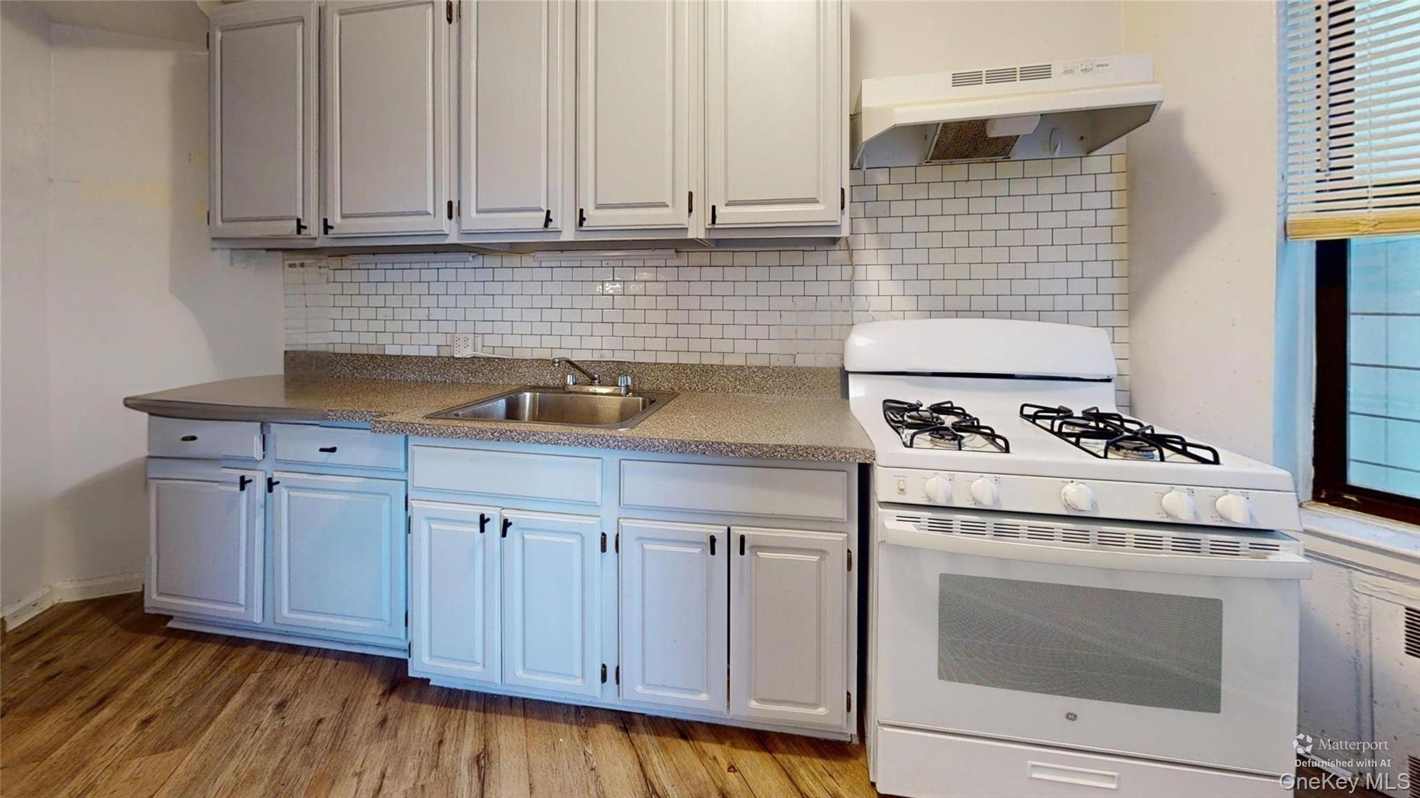 123-35 82nd Road, Unit 3Q Queens, NY 11415 - Photo 3 of 15 a kitchen with granite countertop white cabinets and white appliances