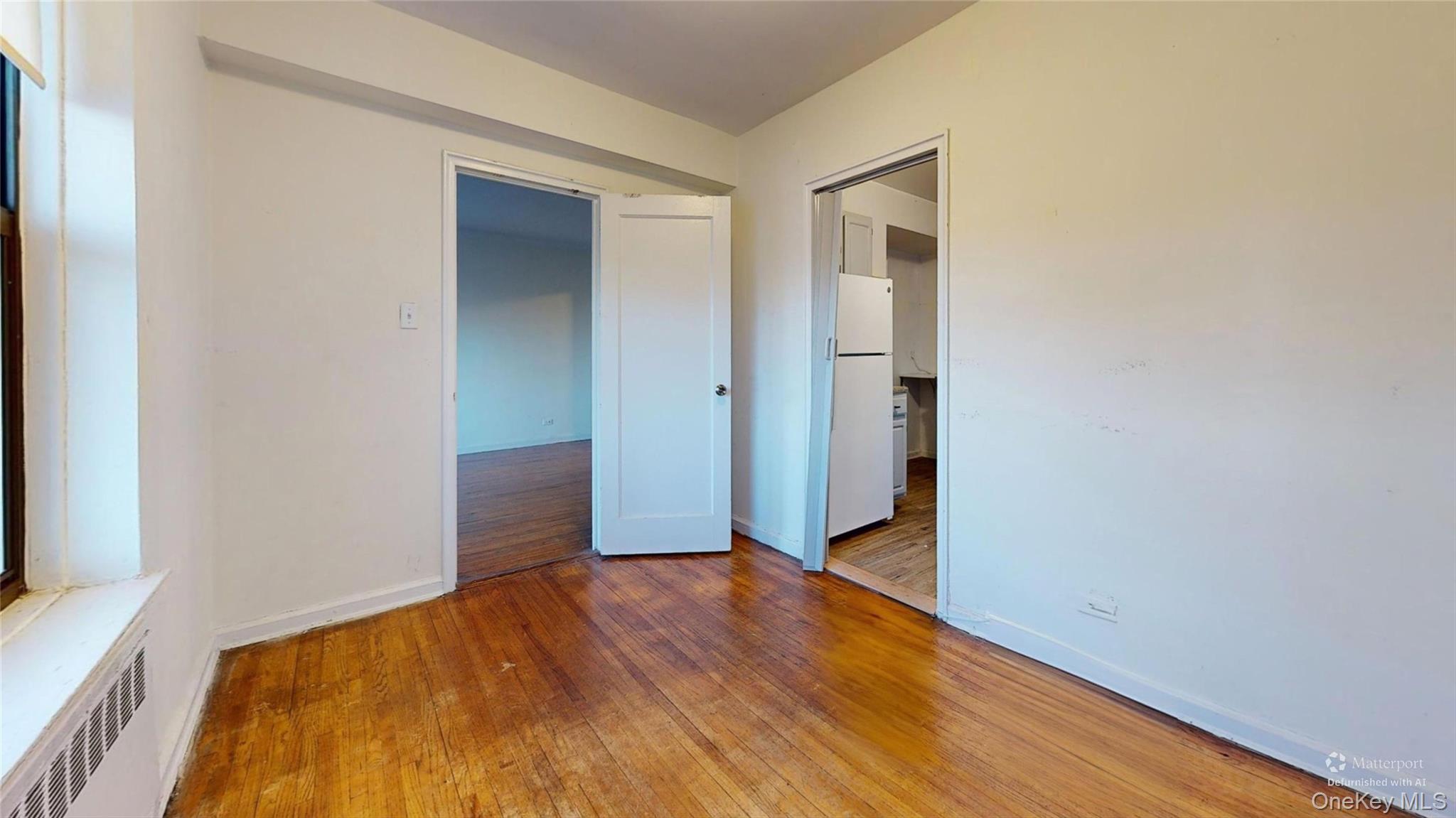 123-35 82nd Road, Unit 3Q Queens, NY 11415 - Photo 5 of 15 a view of empty room with wooden floor