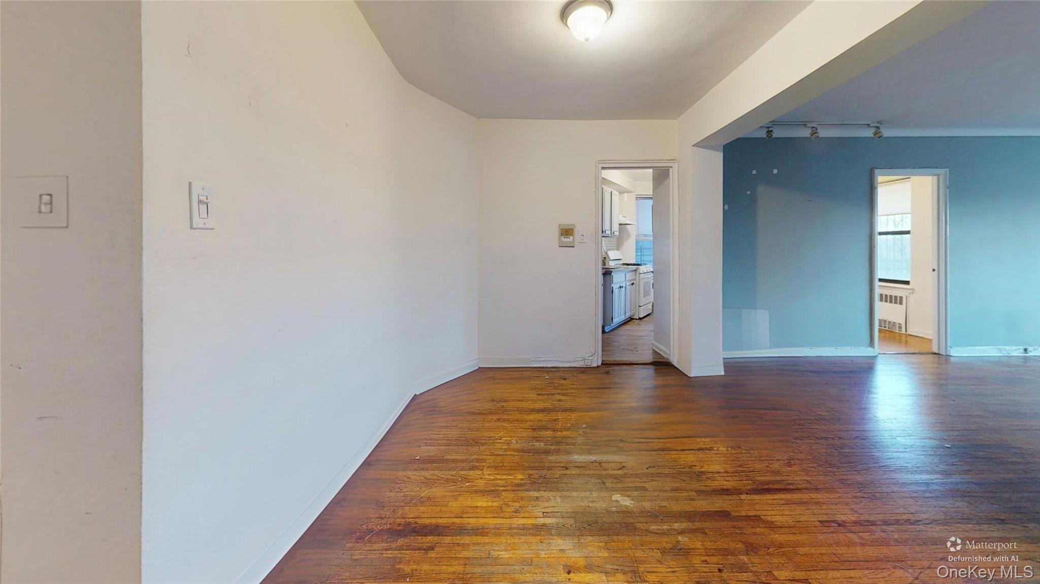 123-35 82nd Road, Unit 3Q Queens, NY 11415 - Photo 7 of 15 a view of an empty room with wooden floor and closet