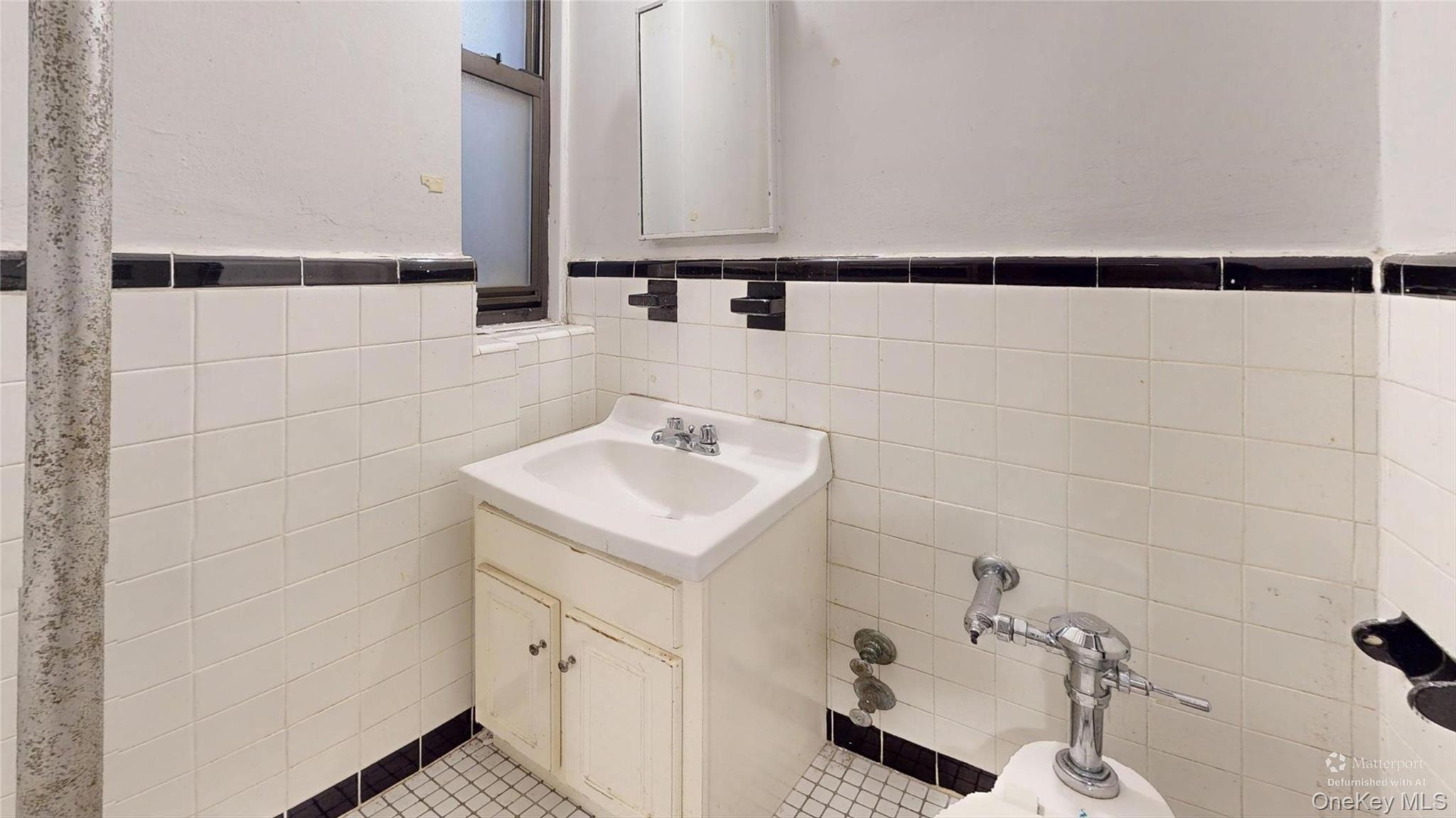 123-35 82nd Road, Unit 3Q Queens, NY 11415 - Photo 9 of 15 a bathroom with a sink and a mirror