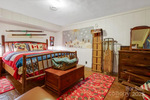 a bedroom with furniture and a wooden floor