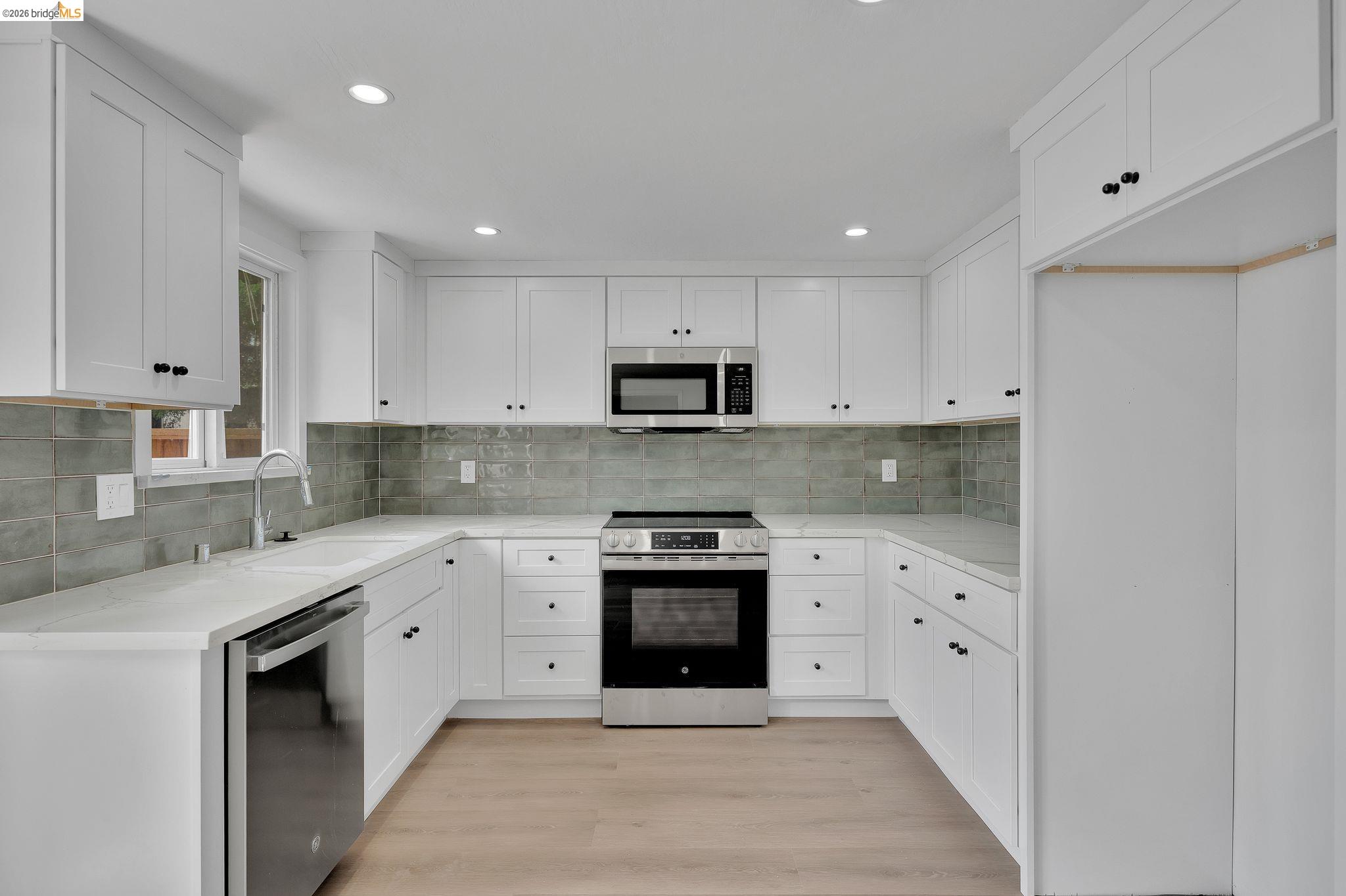 1808 Wildbrook Court, Unit D Concord, CA 94521 - Photo 12 of 47 a kitchen with stainless steel appliances granite countertop a stove a sink and a microwave