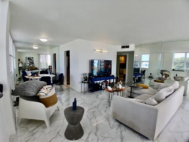 a kitchen with granite countertop stainless steel appliances a sink stove and refrigerator