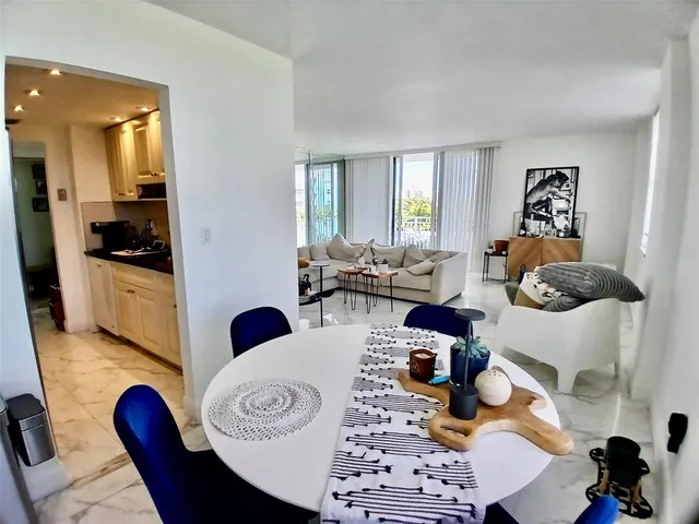 a kitchen with a sink a refrigerator and cabinets