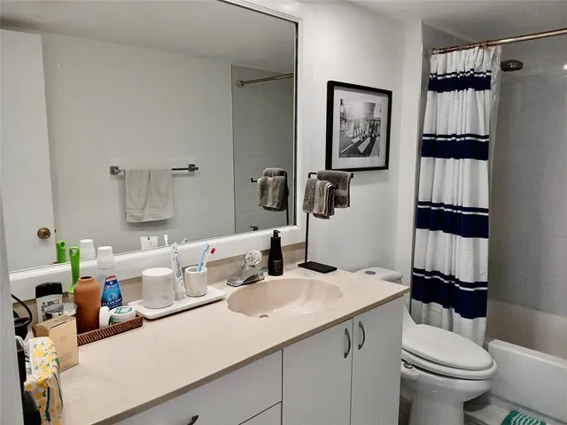 a bathroom with a sink vanity and mirror