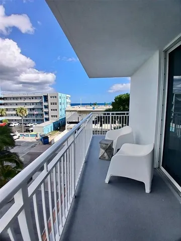 a balcony with furniture and city view