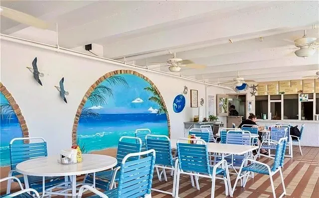 a view of a patio with table and chairs and potted plants