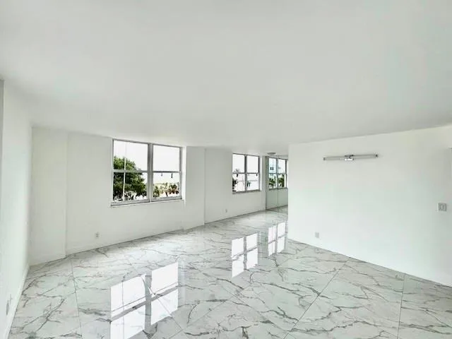 a view of a room with window and hardwood floor