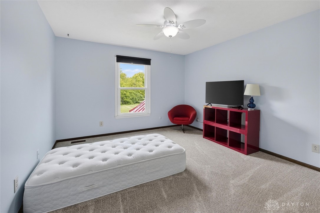 2165 Stewart Road Xenia, OH 45385 - Photo 29 of 59 This cozy bedroom features light walls and soft carpet, providing a comfortable and inviting atmosphere.