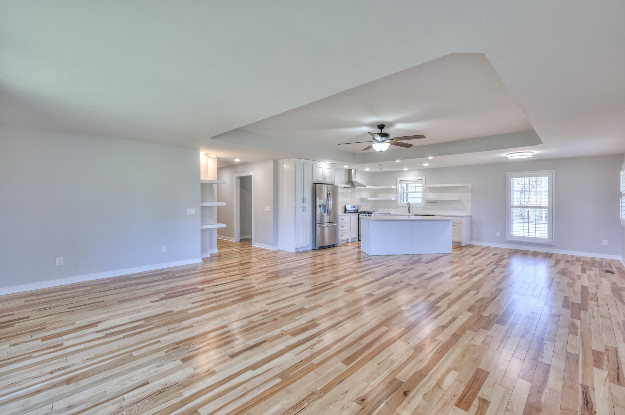 1059 South Cross Bridges Road Mount Pleasant, TN 38474 - Photo 27 of 53 a view of an empty room with wooden floor and a kitchen