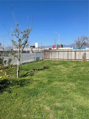 a view of a garden with a building in the background