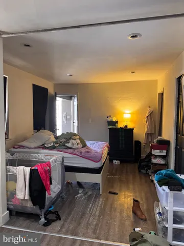 a living room with furniture a flat screen tv and a table