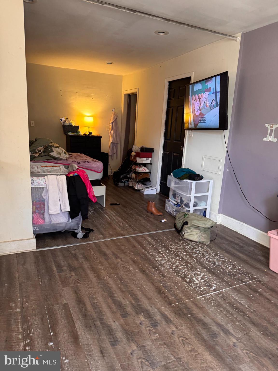 5432 Vine Street, Unit DOWNSTAIRS1 Philadelphia, PA 19139 - Photo 4 of 7 a living room with furniture a flat screen tv and a table