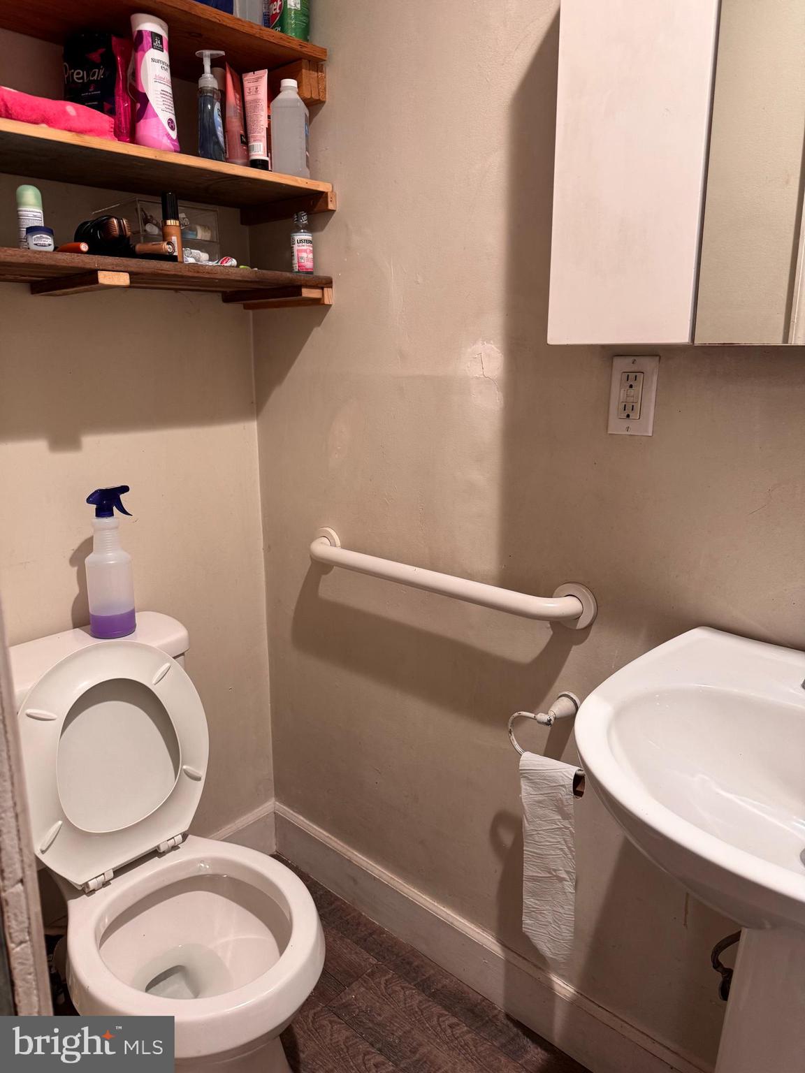 5432 Vine Street, Unit DOWNSTAIRS1 Philadelphia, PA 19139 - Photo 6 of 7 a bathroom with a toilet a sink and a mirror