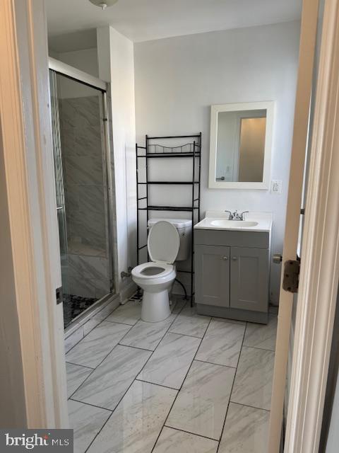 2811 East Venango Street Philadelphia, PA 19134 - Photo 14 of 18 a bathroom with a toilet a sink and mirror