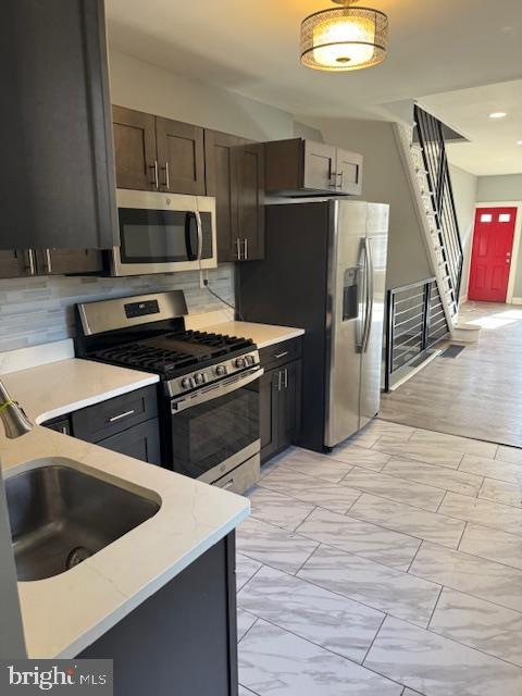 2811 East Venango Street Philadelphia, PA 19134 - Photo 5 of 18 a kitchen with granite countertop a refrigerator and a stove top oven
