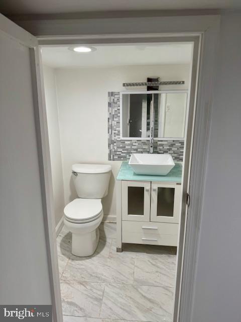 2811 East Venango Street Philadelphia, PA 19134 - Photo 10 of 18 a bathroom with a toilet sink and mirror
