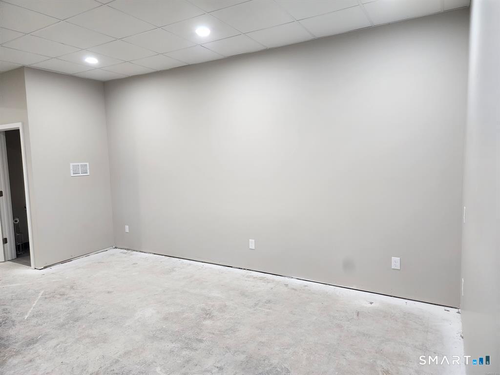 16 Church Street Voluntown, CT 06384 - Photo 3 of 12 an empty room with a workbench
