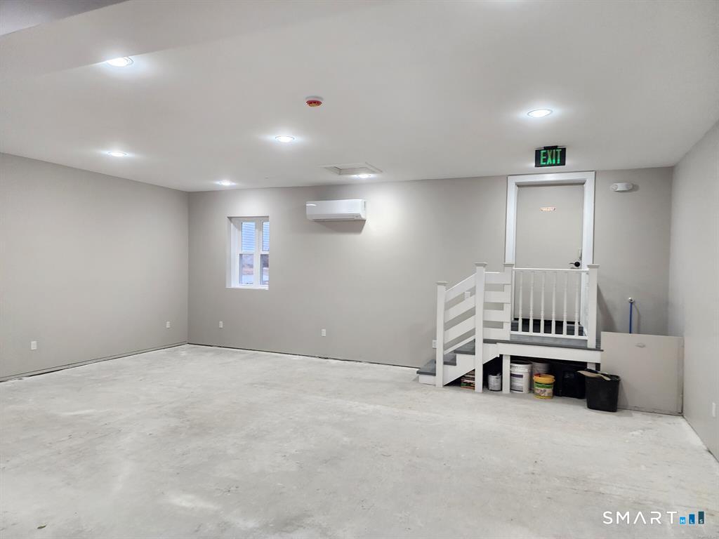 16 Church Street Voluntown, CT 06384 - Photo 4 of 12 an empty room with a table and a chair