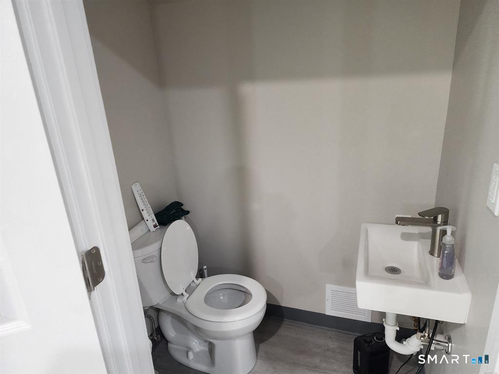 16 Church Street Voluntown, CT 06384 - Photo 7 of 12 a bathroom with a sink toilet and a mirror