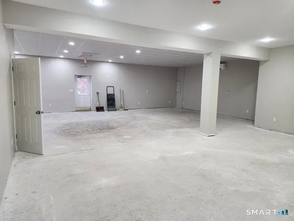 a view of a room with gym equipment and a table