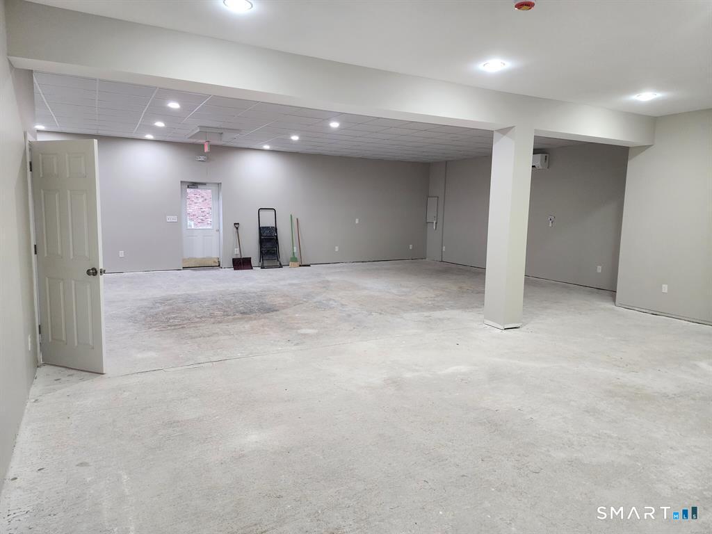 16 Church Street Voluntown, CT 06384 - Photo 8 of 12 an empty room with a projector and a workspace