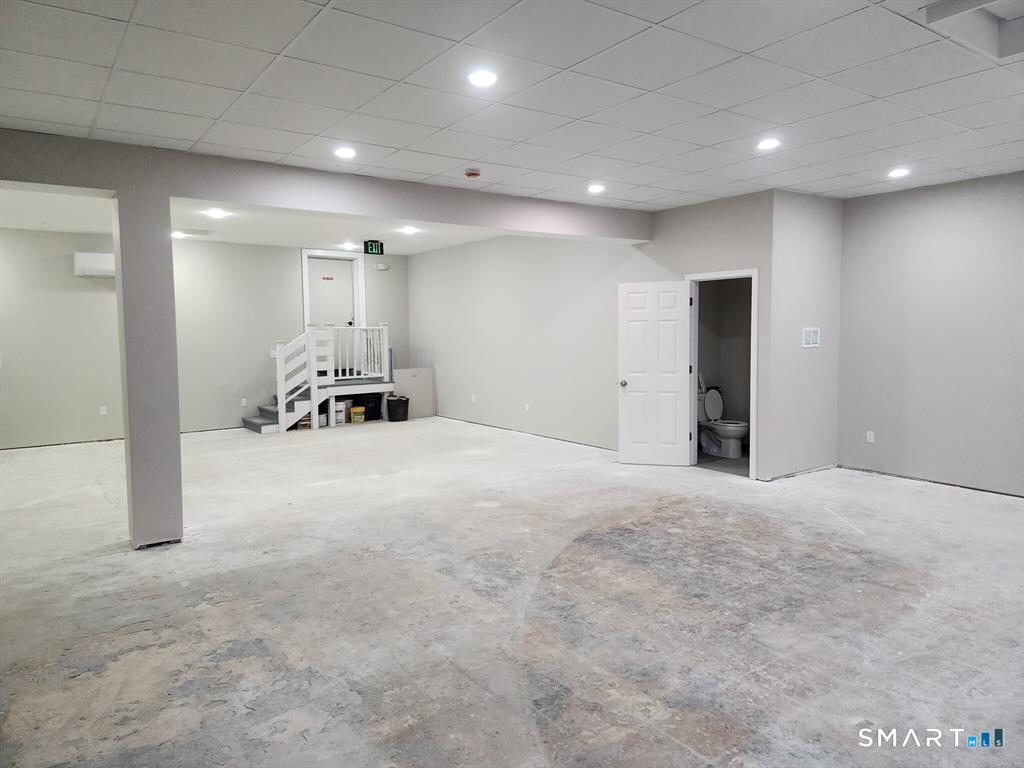 16 Church Street Voluntown, CT 06384 - Photo 9 of 12 a view of a room with gym equipment and a table