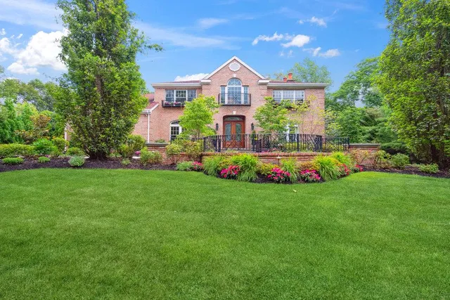 a front view of house with yard and green space