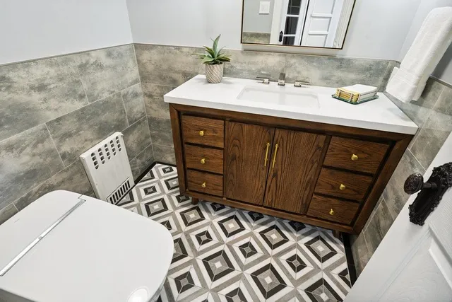 a bathroom with a sink mirror and vanity
