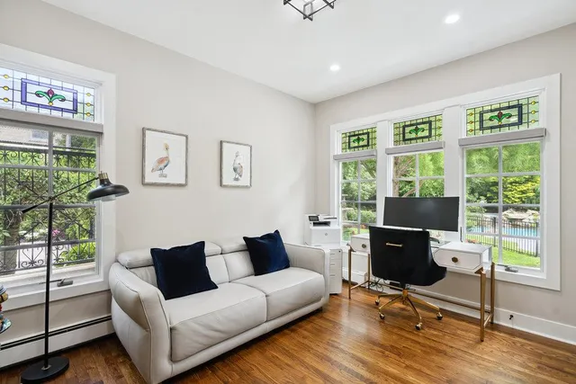 a living room with furniture and a floor to ceiling window