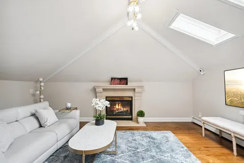 a living room with furniture fireplace and window