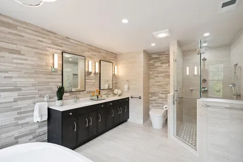 a bathroom with a double vanity sink a toilet and a shower