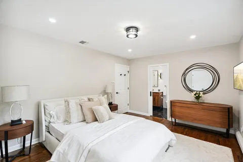 a bedroom with bed and a chandelier