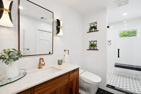 a bathroom with a sink toilet and shower