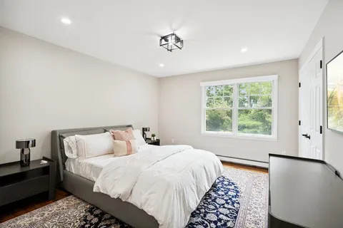 a bedroom with a large bed and a window