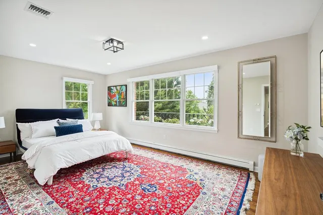 a bedroom with a large bed and a window