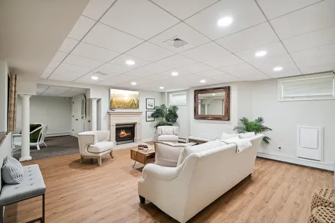a living room with fireplace furniture and a wooden floor