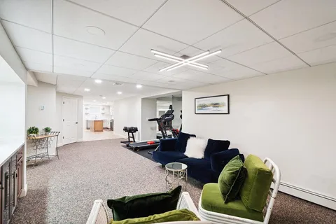 a living room with furniture and a chandelier