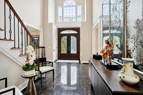 a view of hall way with furniture and rug