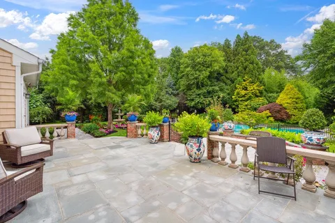 a view of a chairs and table in the back yard of the house