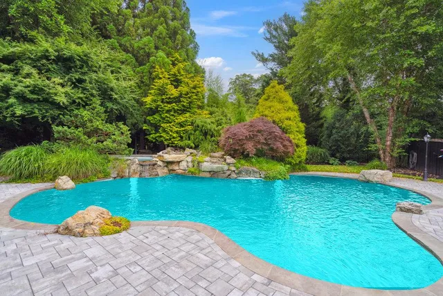 a view of a backyard with swimming pool