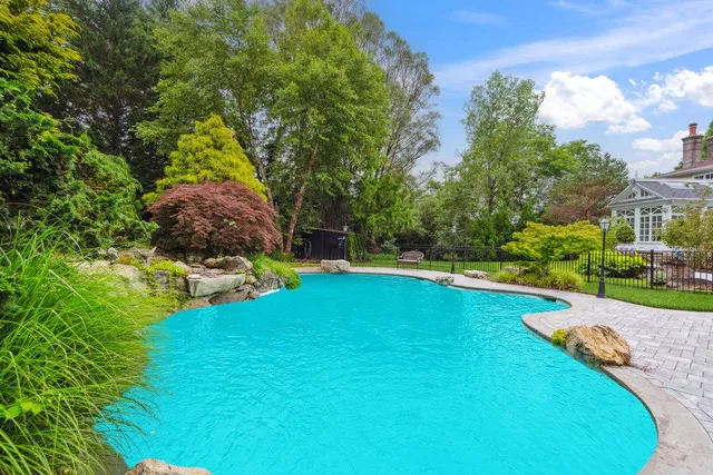 a view of a backyard with swimming pool
