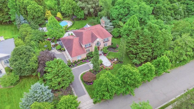 an aerial view of a house with garden space and street view