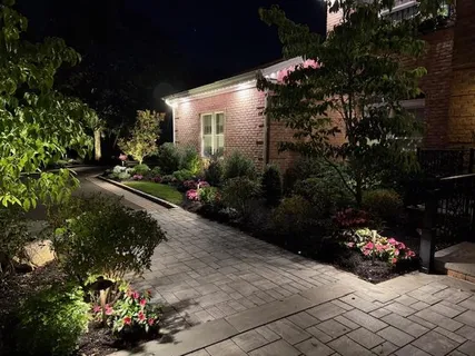 a front view of a house with a yard and a garden