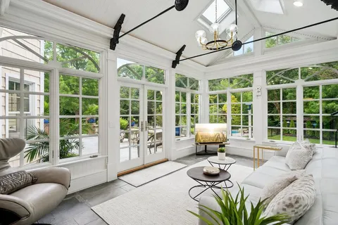 a living room with furniture and large windows