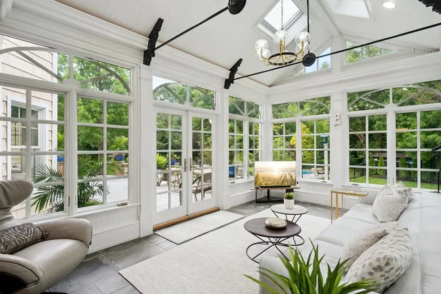 a living room with furniture and large windows