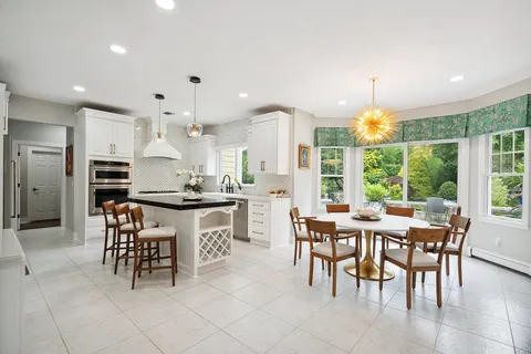 a large kitchen with a table and chairs