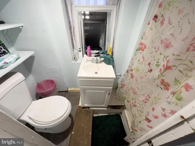 a white toilet sitting next to a bathroom sink